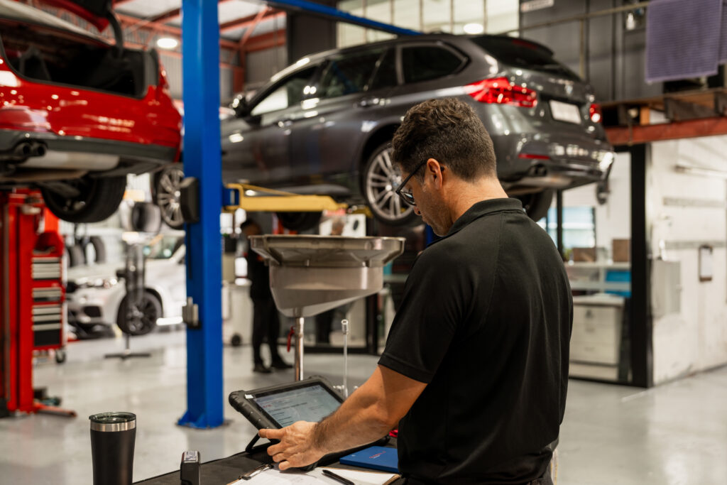 mechanic doing safety roadworthy certificate and logbook service